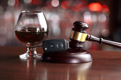 A glass of red wine, a car key and a gavel placed on a desk - McGrath Law Firm - DUI Lawyers - Mount Pleasant, SC.