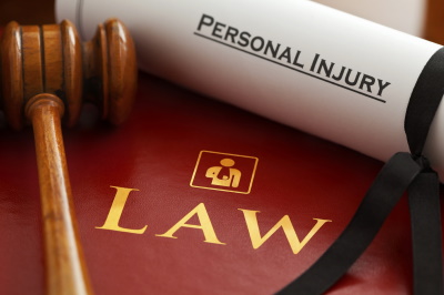 Personal Injury typed on a Piece of Paper, Next to a Law Book and Gavel - McGrath Law Firm - Personal Injury Lawyers - Mount Pleasant, SC