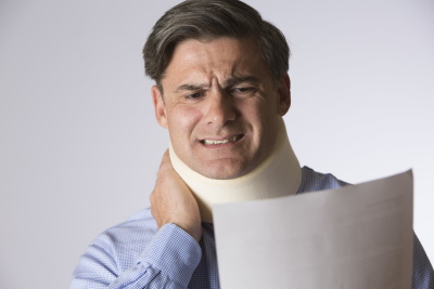 A man has his right hand on his neck brace and his left hand holding papers, McGrath Law Firm, Personal Injury Lawyers, Mt. Pleasant, SC