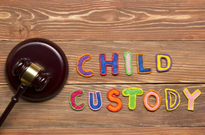 The words Child Custody next to a gavel on a plank of wood, McGrath Law Firm, Child Custody, Mt. Pleasant, S.C.